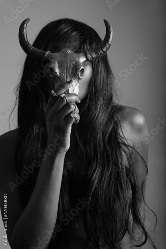 Black and white vertical portrait of gorgeous black young woman with long hair.