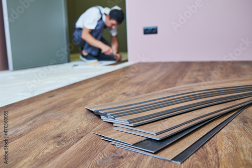 Flooring work. worker joining vinyl floor covering at home renovation