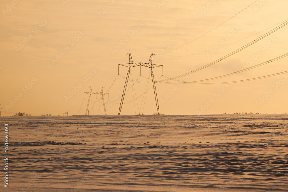 Cold winter daybreak above high voltage power line
