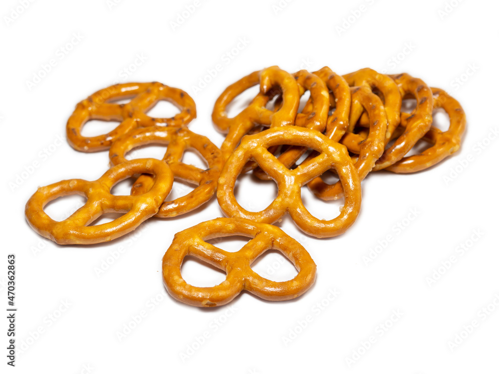 Fototapeta premium Small pretzels on a white background. Baking for tea. Crispy biscuits.