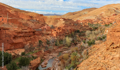 .Traditional Berber village in the Atlas mountains, traditional mountain houses and a canyon with a small river