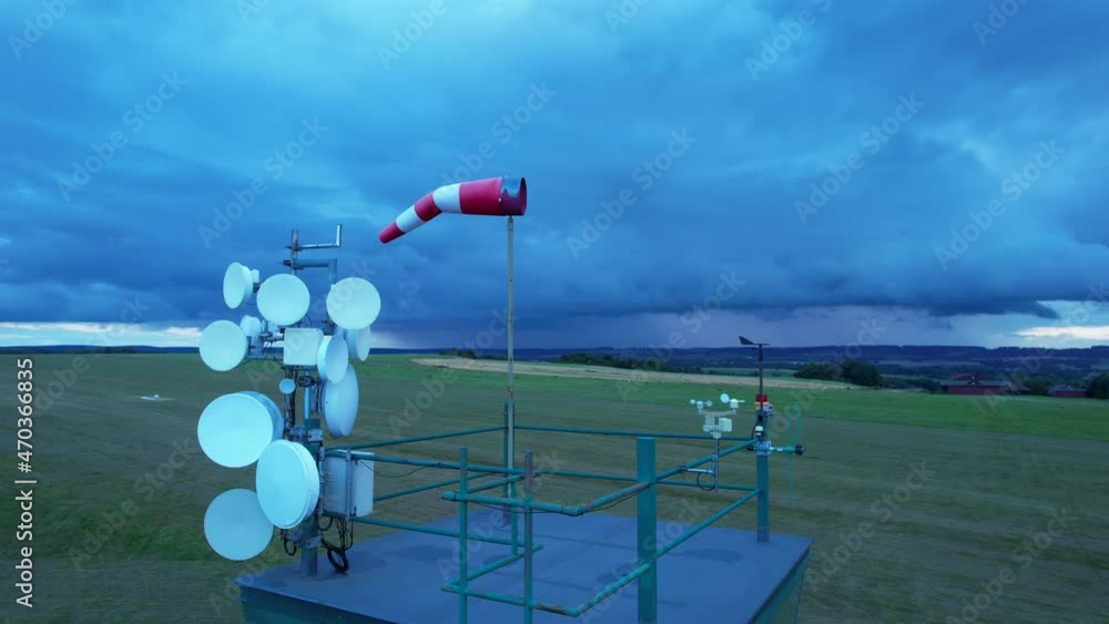 Anemometer and windsock on the tower to measure the direction and speed of the wind to predict weather conditions. Anemometer and windsock on the tower to measure the direction and speed of the wind to predict weather conditions.