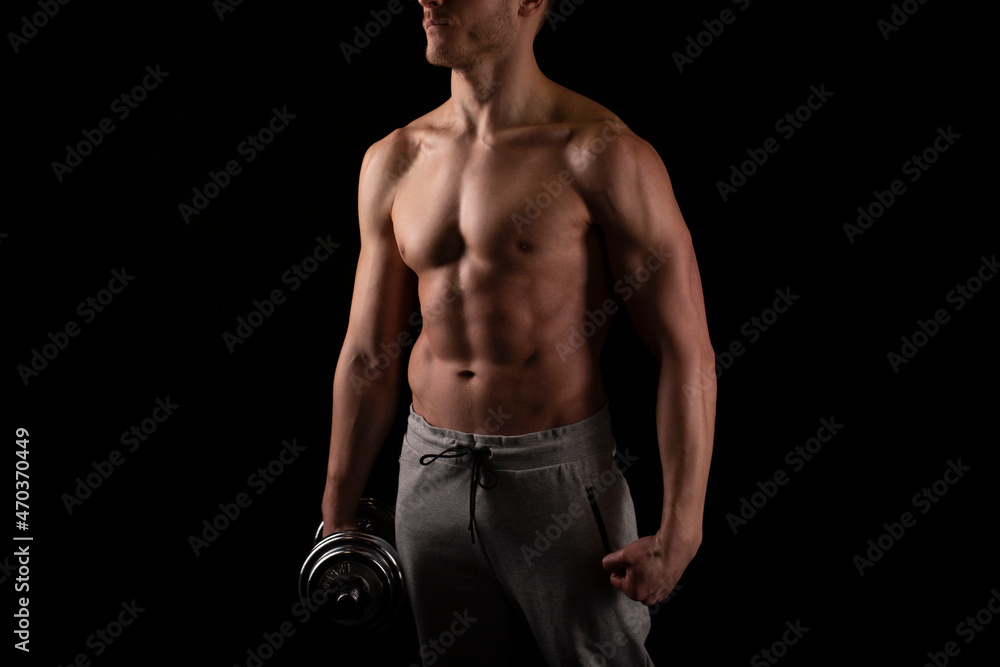 Man Showing ABS. Muscle man Posing with Dumbbell in Hand. Strong Body Concept. Topless Sport man Bodybuilder. Six Pack Spotsman Man Showing ABS. Muscle man Posing with Dumbbell in Hand. Strong Body Concept. Topless Sport man Bodybuilder. Six Pack Spotsman