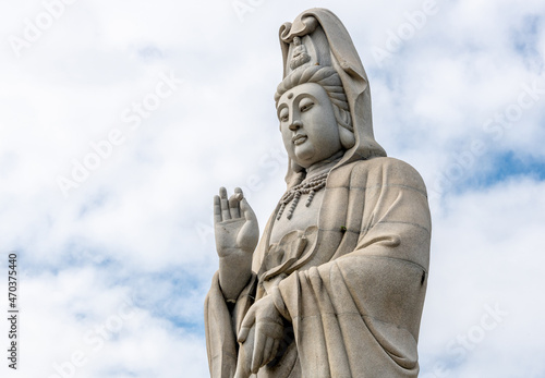 Giant Buddha statue at temple in Kanchanaburi Thailand