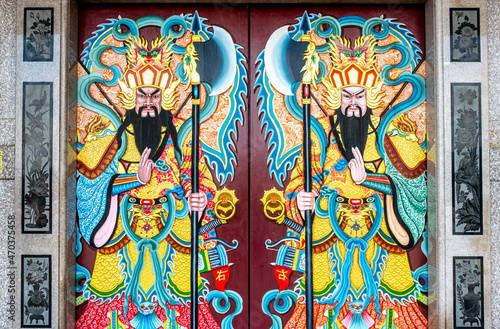 Decorative paintings on a door at a Buddhist temple in Kanchanaburi Thailand