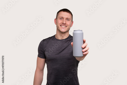 Sportman Showing Tin Can Drink. Energy Drink for Sport. Man with Can in Hands.