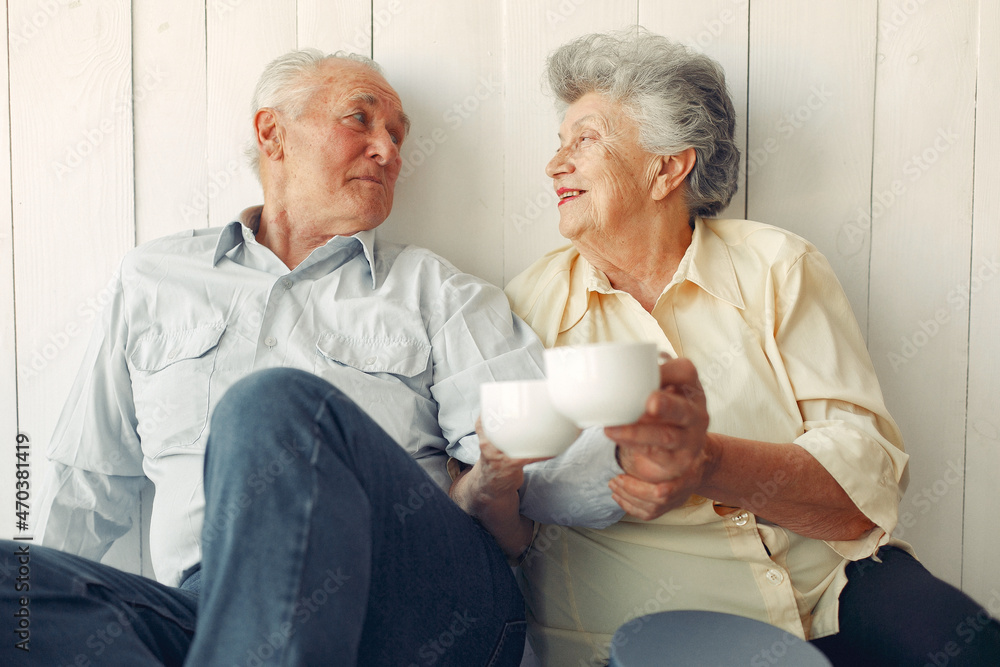 Elegant old couple sitting at home on a foor Elegant old couple sitting at home on a foor