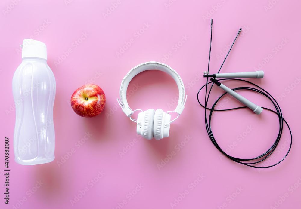 Sports equipment items on pink background, flat lay.