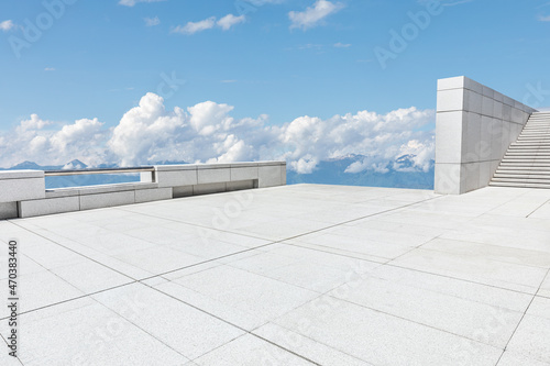 Empty square floor and mountains under blue sky