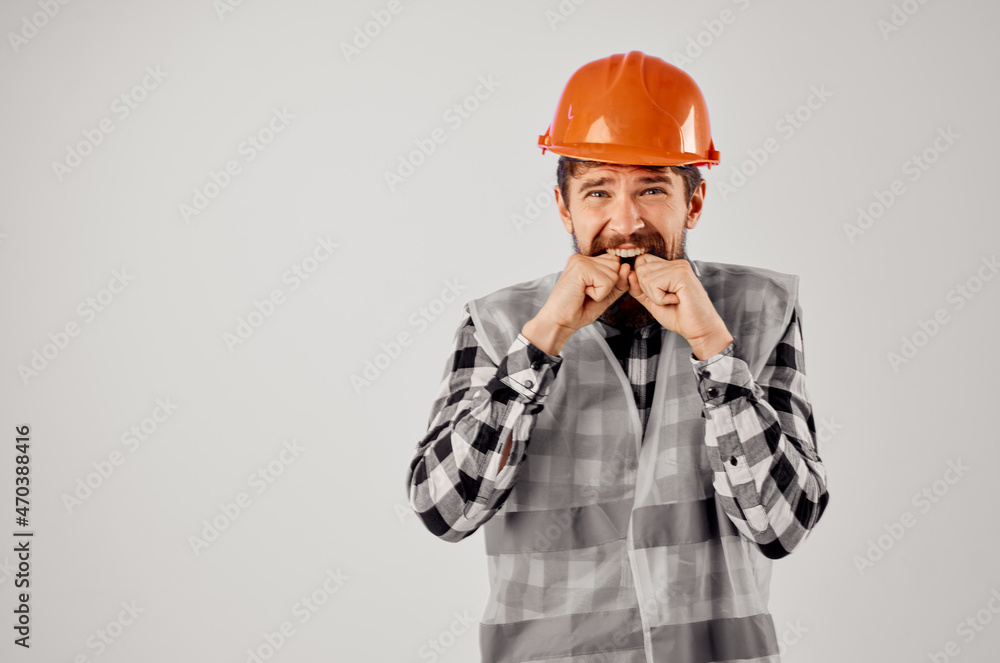 male worker in a gray vest construction work design light background male worker in a gray vest construction work design light background