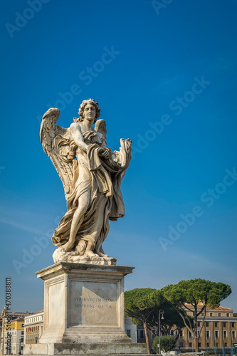 Angel with the Garment and Dice on Ponte Sant Angelo  Bridge of Hadrian  in front of Castel Sant Angelo  Castle of the Holy Angel   in Parco Adriano  Rome  Italy