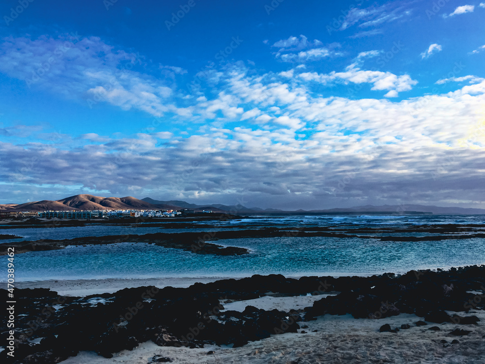 Deep blue water and black Beach on Playa de la concha, Los Lagos, Fuerteventura. Canary Islands, Europe.