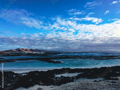 Deep blue water and black Beach on Playa de la concha, Los Lagos, Fuerteventura. Canary Islands, Europe.