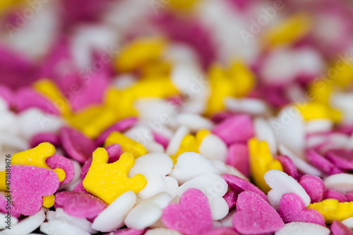 Sprinkle sugar with hearts and crowns, decoration for cakes, candy background.