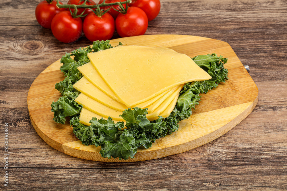 Sliced Gauda cheese over board Sliced Gauda cheese over board