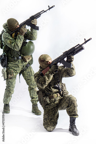 Members of the special purpose unit. Two Russian special forces soldiers with AK assault rifles in camouflage. Portrait on a white background.