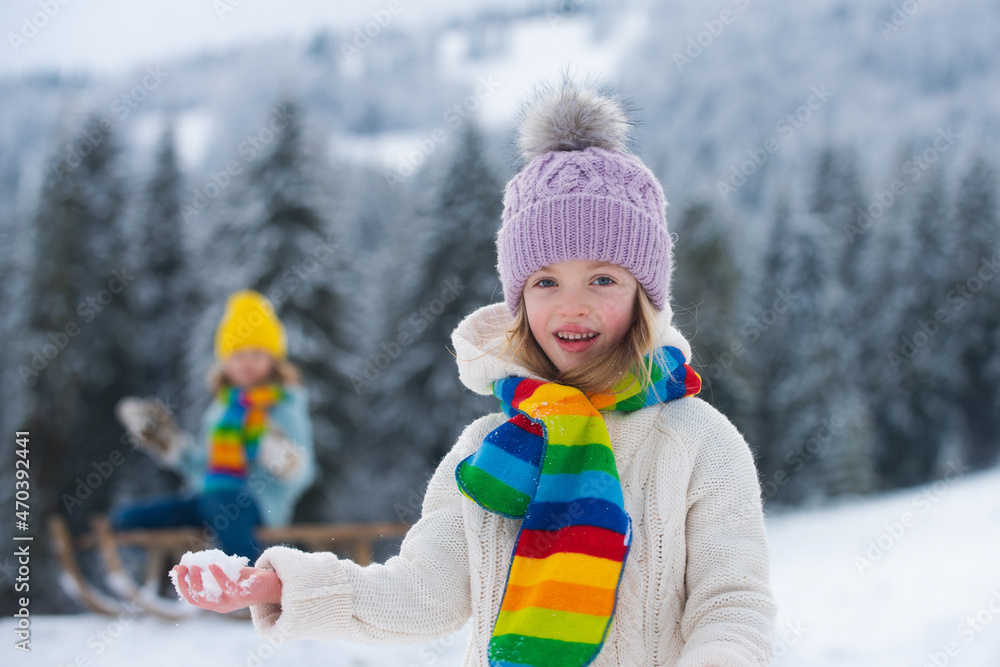 Cute children boy and girl playing on a winter walk in nature. Portrait of happy little kids wearing winter clothes. Cute children boy and girl playing on a winter walk in nature. Portrait of happy little kids wearing winter clothes.