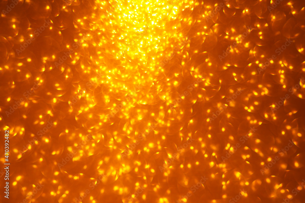 Defocused golden glitter. Glowing holiday bokeh background