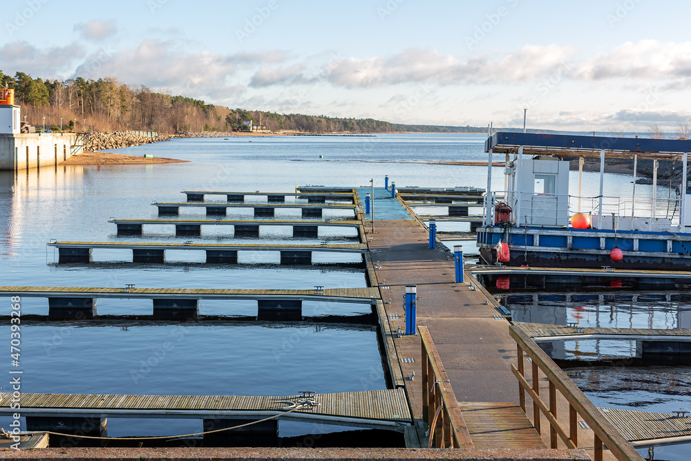 Berth for boats and speedboats. An old empty pier on the seashore. Autumn at sea - obrazy, fototapety, plakaty 