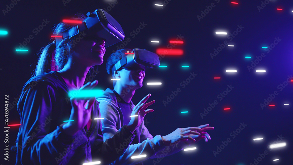 Metaverse VR virtual reality game playing, man and woman play metaverse virtual digital technology game control with VR goggle