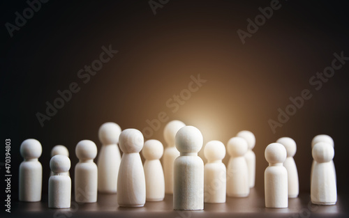 selection concept. Human Resources Management  talent recruitment leadership. Wooden doll on black background. With copy space.