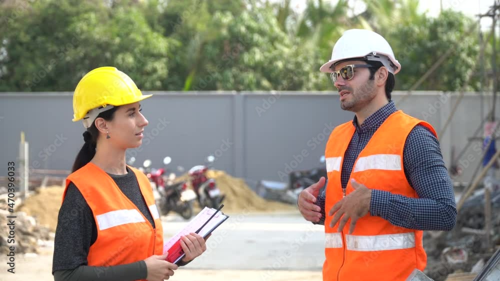 architect man and foreman women discuss with paper checking list and audit on construction site at village . contractor worker Inspection with builder. architect man and foreman women discuss with paper checking list and audit on construction site at village . contractor worker Inspection with builder.