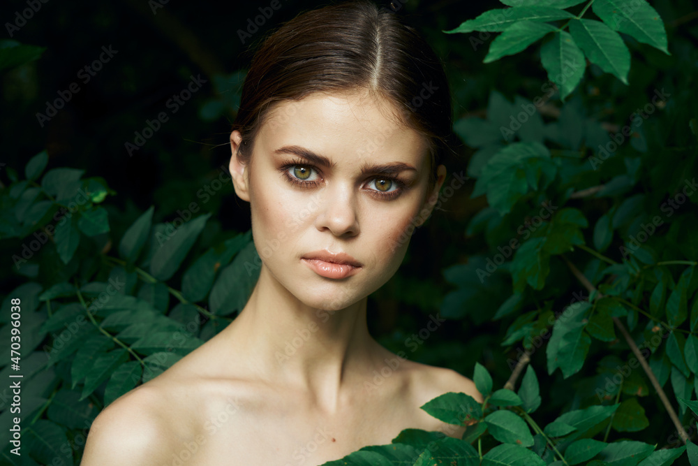 attractive woman skin care bare shoulders green leaves nature close-up attractive woman skin care bare shoulders green leaves nature close-up