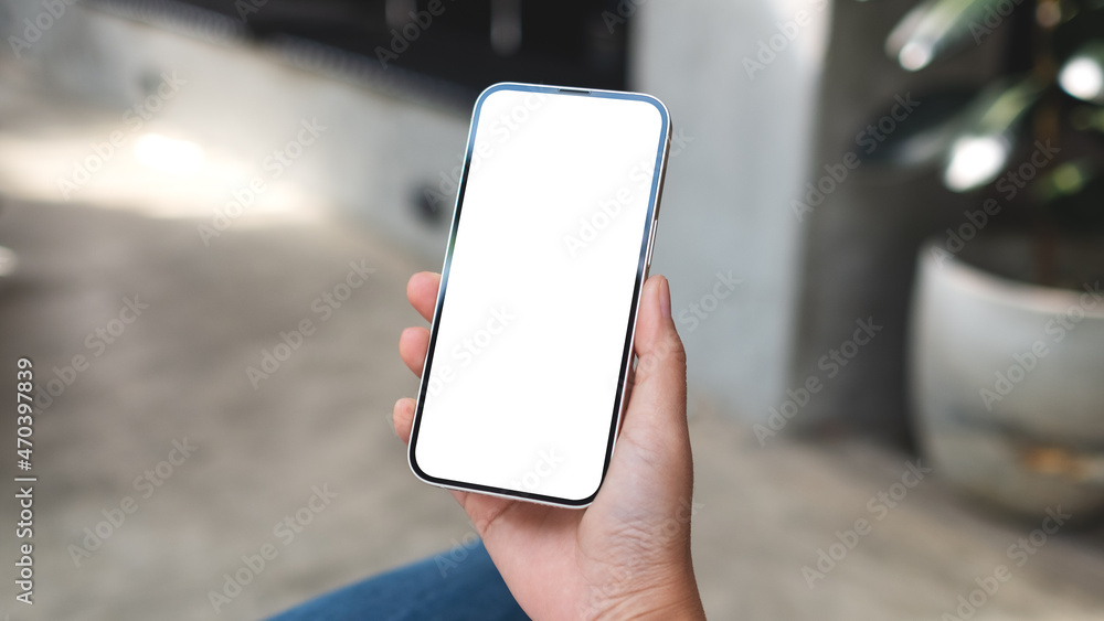 Mockup image of hands holding mobile phone with blank desktop screen