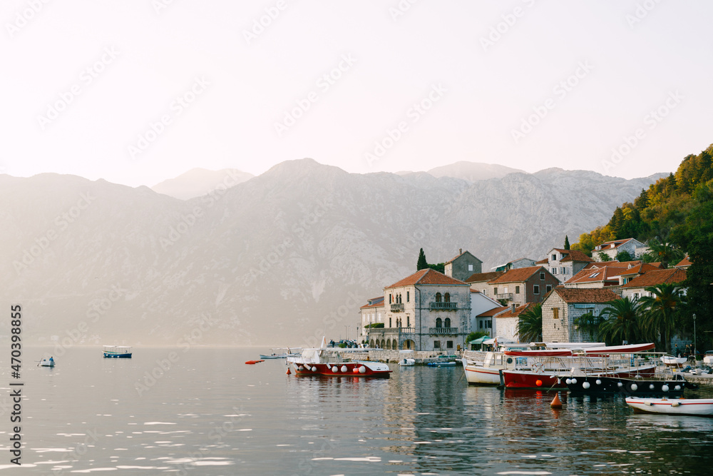 Boats on the pier of Perast against the background of mountains. Montenegro