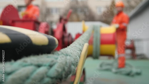 Sturdy nylon sling stowing and going from a bollard to a  worker with a wrinch. 