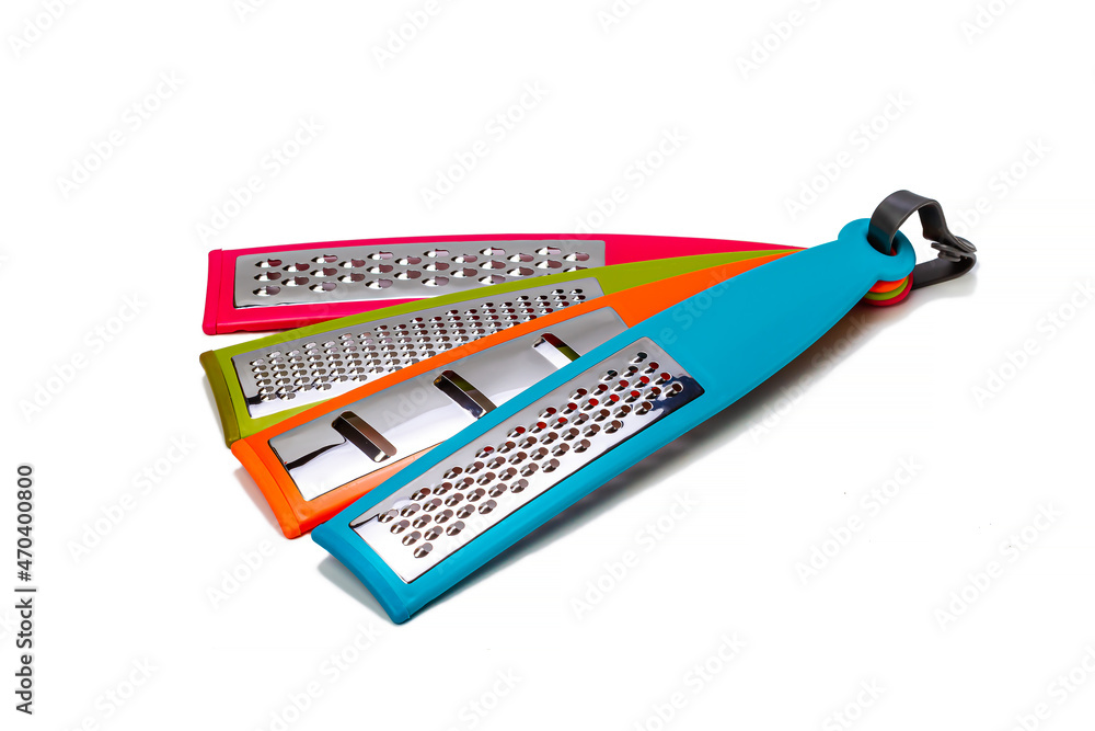 Various multicolored vegetable graters on a white isolated background. Kitchenware. Various multicolored vegetable graters on a white isolated background. Kitchenware.