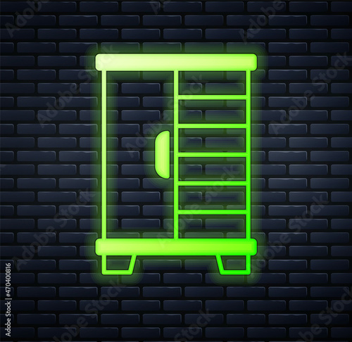 Glowing neon Wardrobe icon isolated on brick wall background. Cupboard sign. Vector