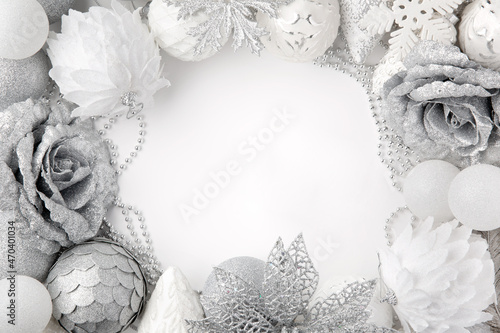 Christmas decor. White and silver colors. Monochrome. Christmas balls, decorations on a white background. Top view. Space for text. photo