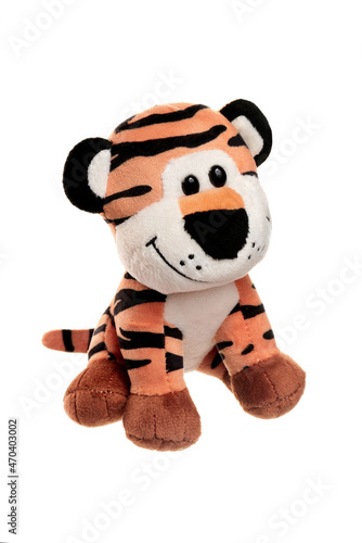 The little tiger cub is sitting. Soft Christmas toy. The symbol of the new year. 