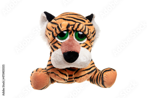Serious tiger symbol of the year sits. A soft toy for Christmas.