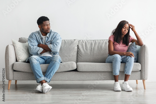 Young married black couple having fight, ignoring each other
