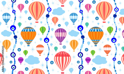 Vector seamless pattern with hot air balloons, evil eyes amulets (nazar), beads, clouds and stars in a flat style. Inspired with Turkey and Cappadocia.  