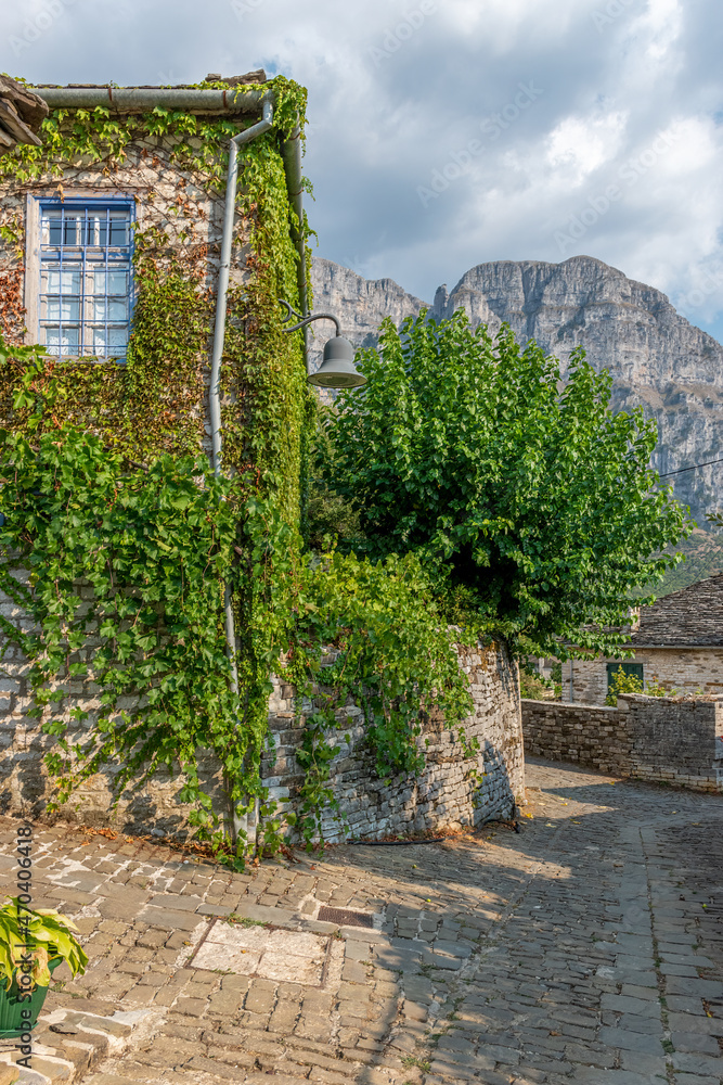 Traditional architecture with  stone buildings and  astraka mountain as background during  fall season in the village Papigo in zagori Greece