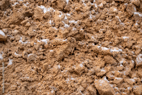 Textural sand  with  relief surface  multi-colored layers and different in size of granules  in outdoor sand career  after mining ore and sand for construction.