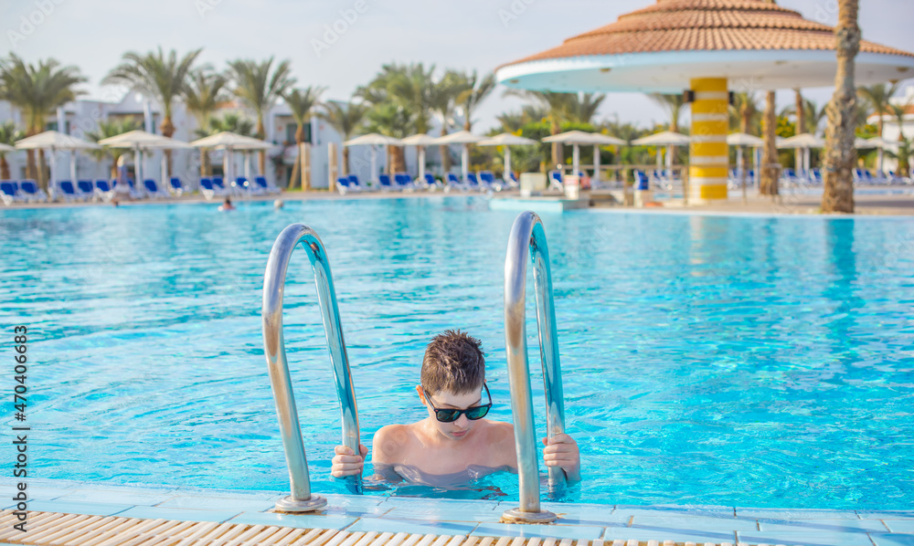 Boy rest in vacation. Teenage boy in swimming pool, Children lifestyle. Enjoy the life Boy rest in vacation. Teenage boy in swimming pool, Children lifestyle. Enjoy the life