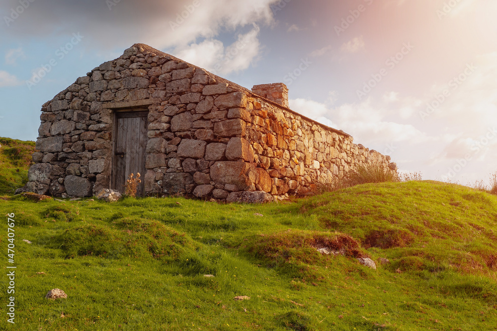 Old abandoned stone house without the roof. Sunset time. Rural Irish farm building. Dramatic sky. Old architecture example. Top quality frame . History and heritage concept. Connemara, Ireland Old abandoned stone house without the roof. Sunset time. Rural Irish farm building. Dramatic sky. Old architecture example. Top quality frame . History and heritage concept. Connemara, Ireland