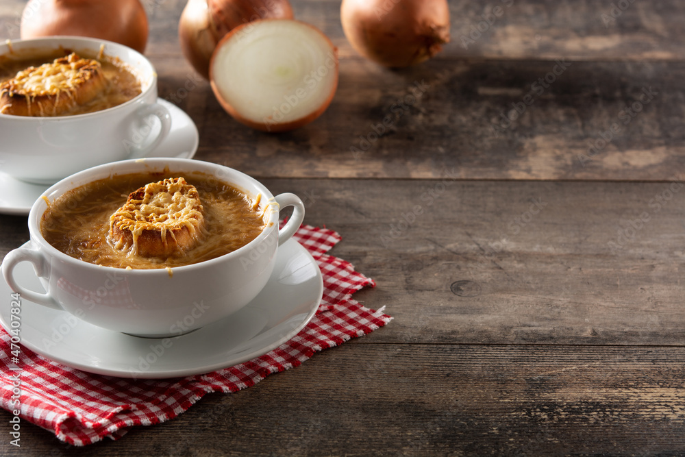 Traditional french onion soup on wooden table. Copy space