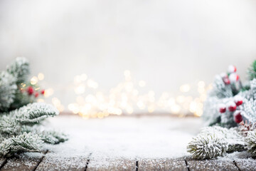 Banner with Christmas decorations on snow with fir tree branches and christmas lights. Winter Decoration Background with copy space for text
