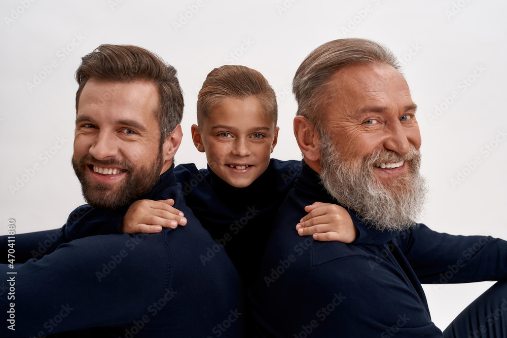 Portrait of smiling three generations of men hugging Portrait of smiling three generations of men hugging