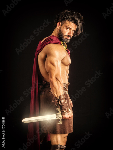 Muscular man posing in roman gladiator costume