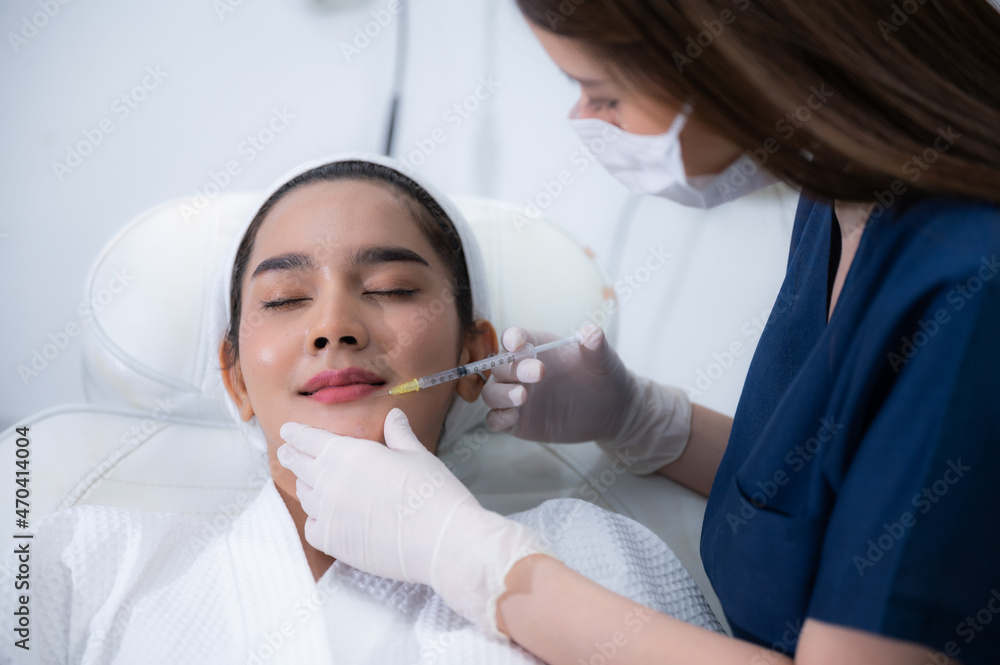 Naklejka premium young Asian woman making cosmetology treatment skin injection, Mesotherapy of face beauty care