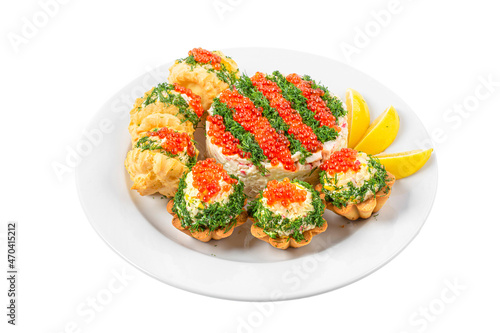 Banquet buffet food. Profiteroles and tartlets stuffed with salad with red caviar in a plate isolated on white background