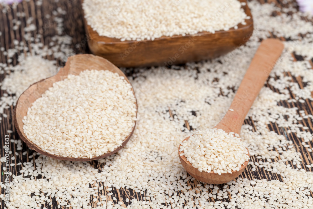 white sesame seeds on a wooden table white sesame seeds on a wooden table