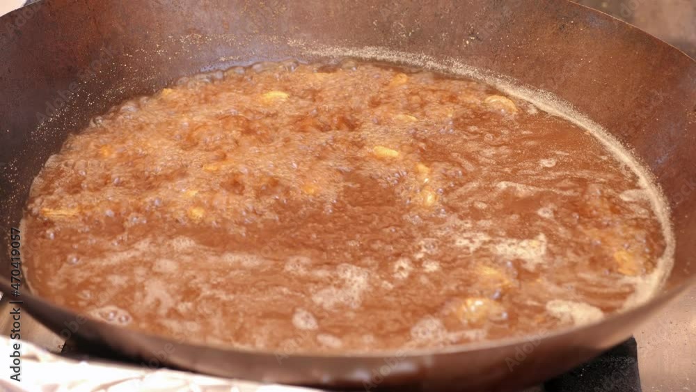 Close-up of a small fish deep-fried in a large amount of oil in the industrial kitchen at the hotel. The power supply is all inclusive. Close-up of a small fish deep-fried in a large amount of oil in the industrial kitchen at the hotel. The power supply is all inclusive.