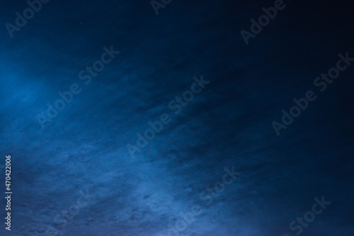 Noctilucent clouds close up on a summer night. Glowing clouds in the night sky.